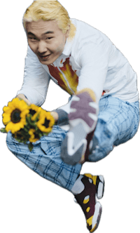 a man with blond hair holding sunflowers